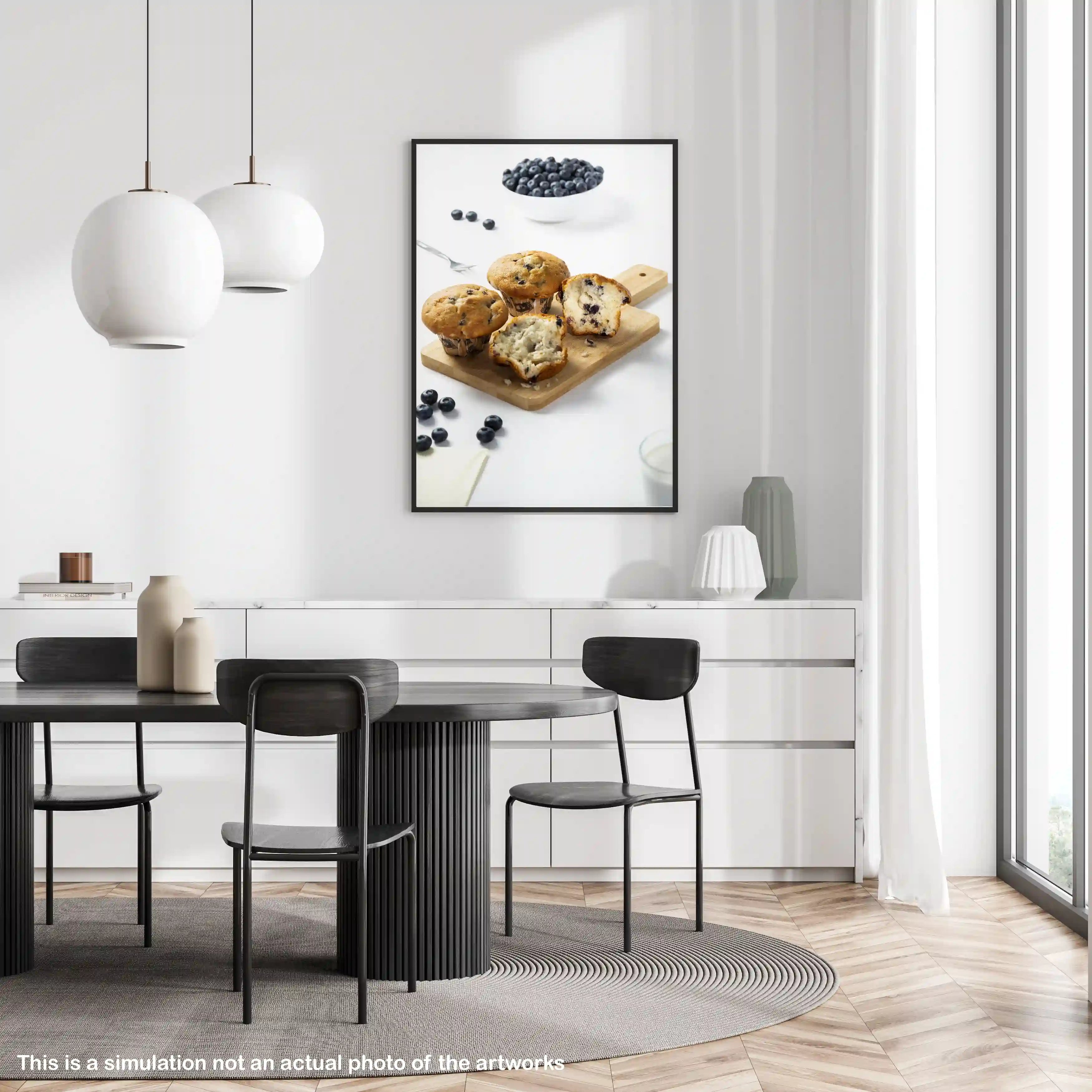 Dining room with a round table and black chairs, featuring a framed picture of muffins on the wall.