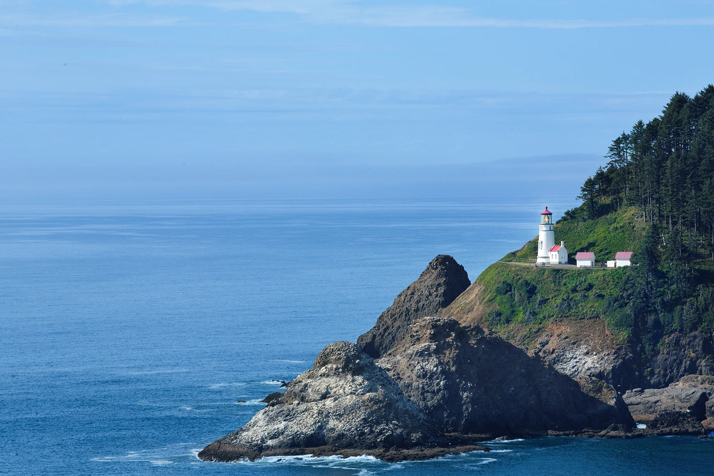 The tranquil beauty of coastal the life in California with this stunning photograph of a solitary lighthouse perched atop a rugged cliff. Bathed in soft daylight and surrounded by the endless expanse of the deep blue Pacific Ocean. Actual format of the artwork.