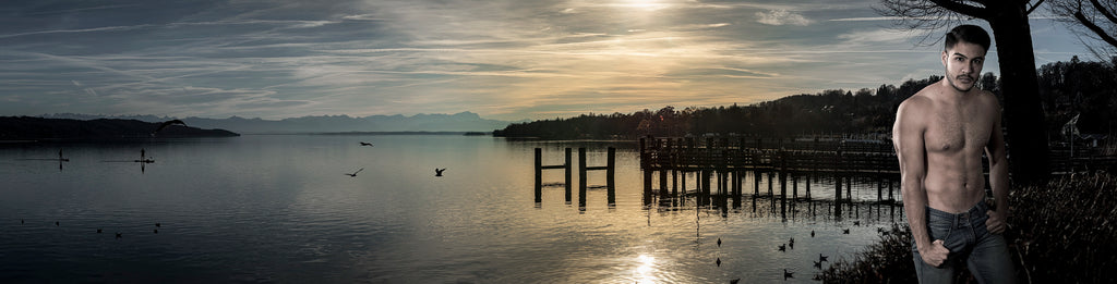 The serene beauty of a tranquil lakeside scene bathed in the fading light of dusk, paired with the poised presence of a man standing confidently at the water’s edge. Actual format of the artwork.