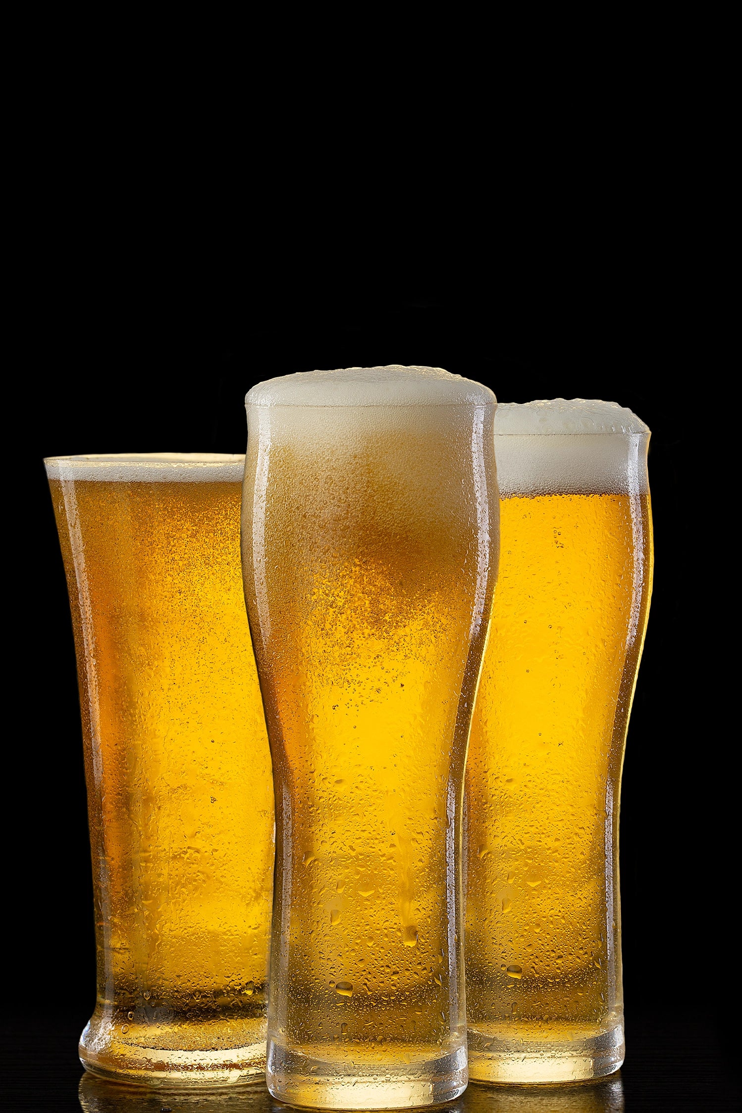 A captivating photograph of three frosty beer glasses. Actual format of the artwork.