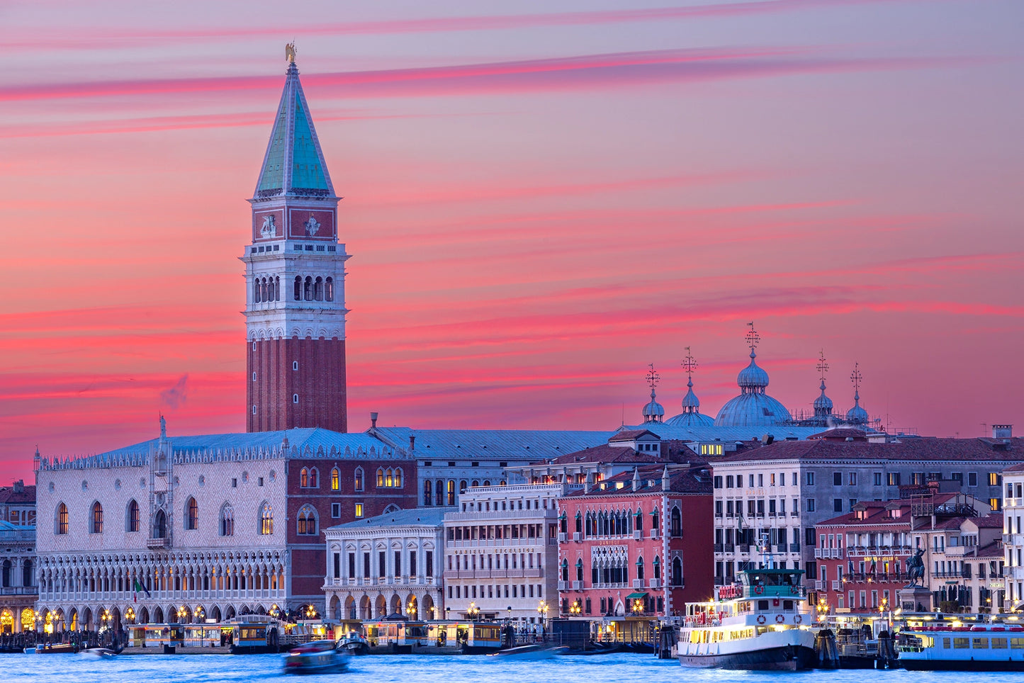 The enchanting skyline of Venice is bathed in the soft, pastel hues of twilight. The iconic St. Mark's Campanile rises majestically above the historic Doge's Palace, with the ethereal beauty of the Basilica di San Marco's domes silhouetted against the vibrant sky. Actual format of the artwork.