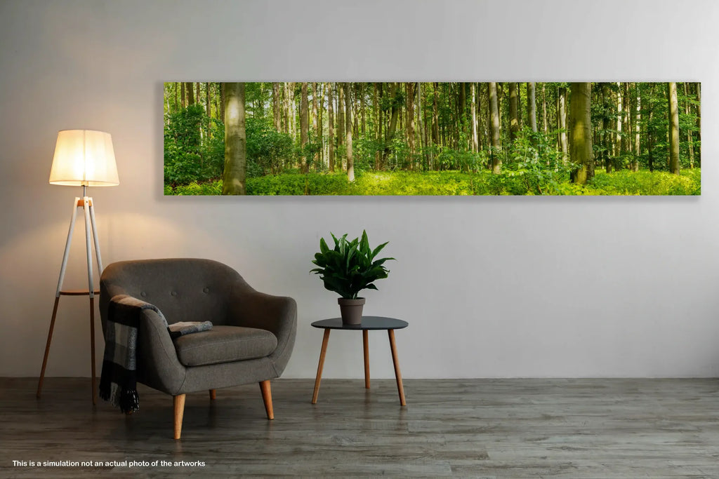 Living room with a gray armchair, small table with a plant, and a large forest painting on the wall.