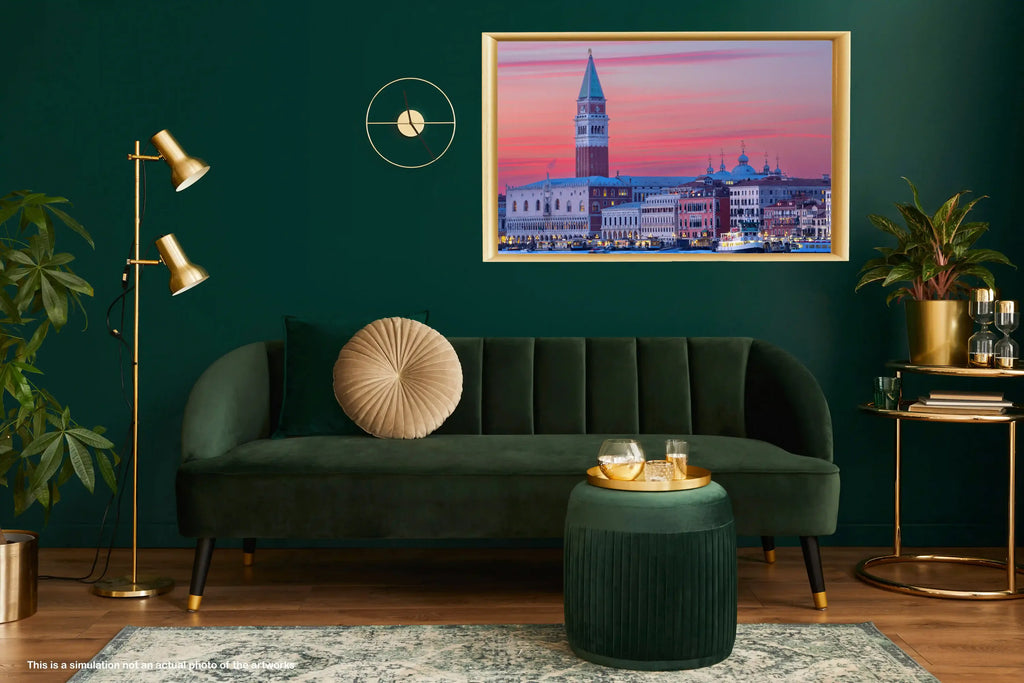 Modern living room with a green sofa, gold lamp, and framed artwork on a dark green wall.